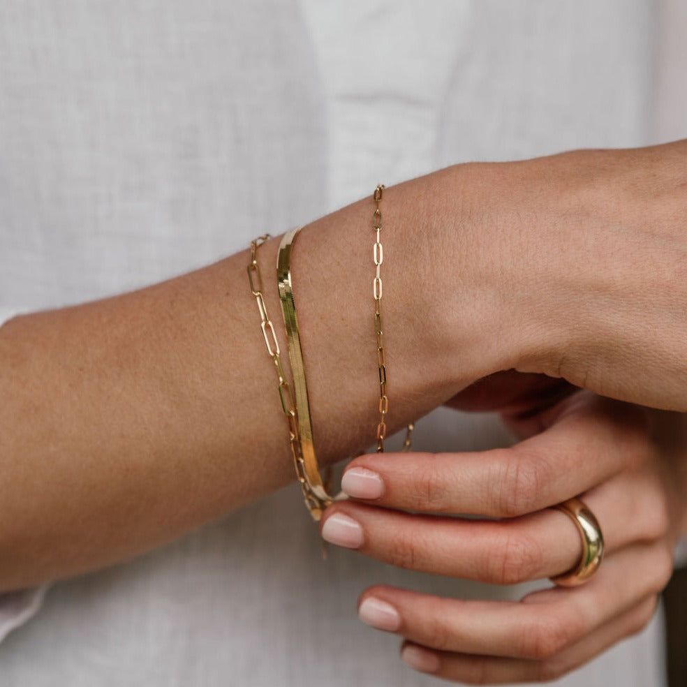 Variety of gold Bracelets on arm