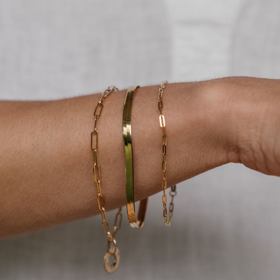 Variety of gold bracelets on arm