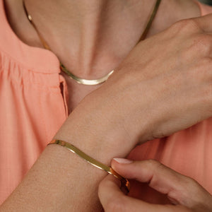 Lady wearing Liquid Gold Necklace and bracelet 