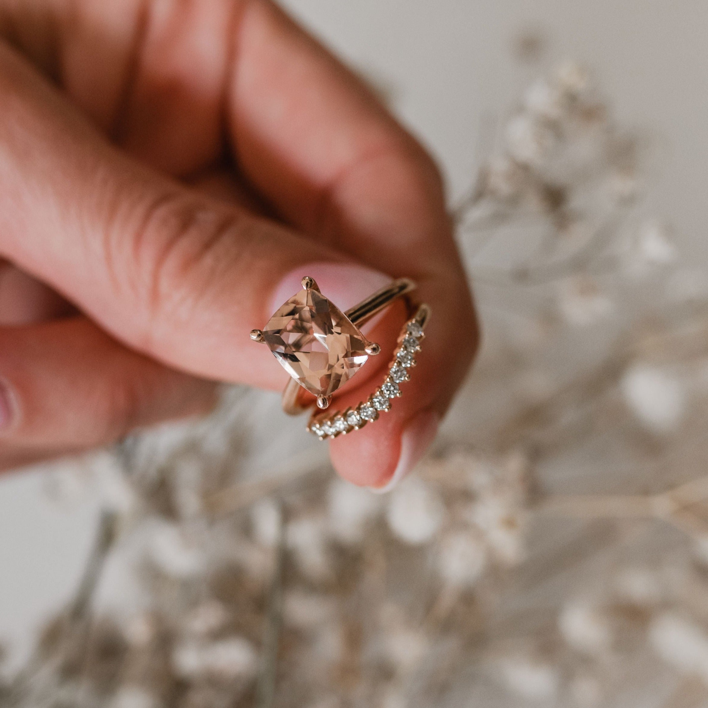 Curved diamond eternity band on finger with morganite ring. with 