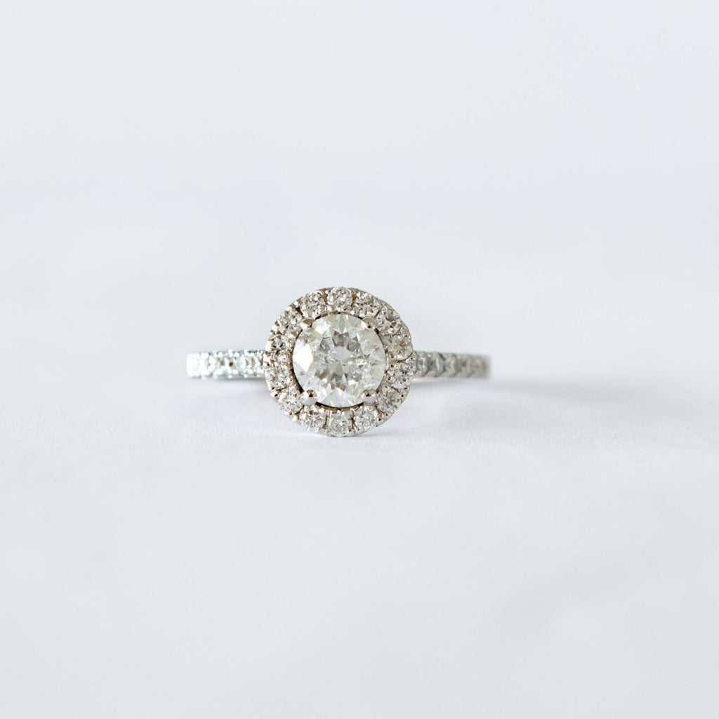 8ct white gold ring with a 0.90ct round brilliant cut diamond as the centre stone and a halo of diamonds surrounding it.