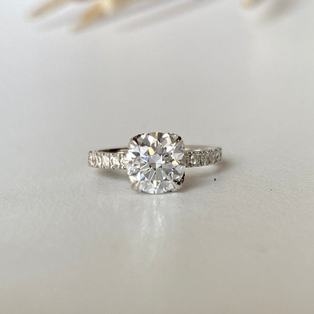 18ct white gold solitaire ring with 1.53ct brilliant cut diamond. The 4 claws are petal shaped and diamond encrusted. 