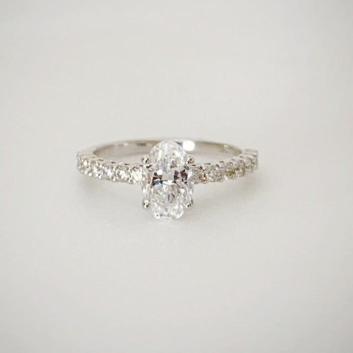 18ct white gold solitaire ring with 1ct oval cut diamond as the centre stone with 0.30ct diamond band.