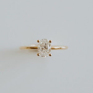 18ct yellow gold solitaire engagement ring with 0.89ct oval cut diamond. The heavily rounded skinny band, measuring 1.5mm.
