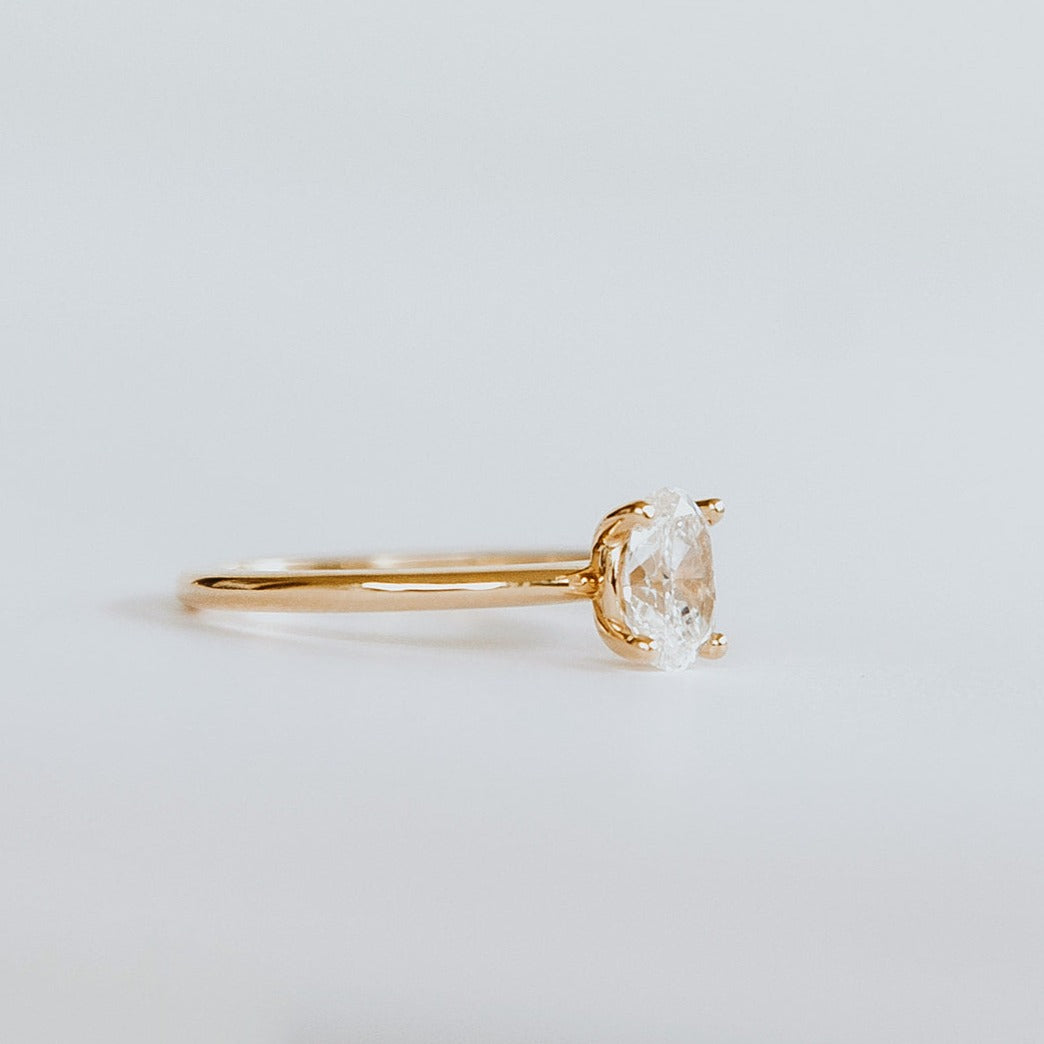 side view of 18ct yellow gold solitaire engagement ring with 0.89ct oval cut diamond. The heavily rounded skinny band, measuring 1.5mm.