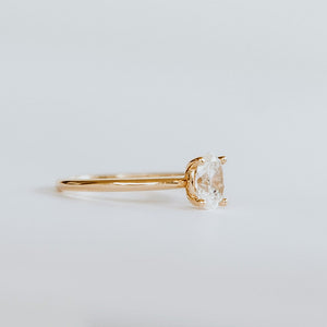 side view of 18ct yellow gold solitaire engagement ring with 0.89ct oval cut diamond. The heavily rounded skinny band, measuring 1.5mm.